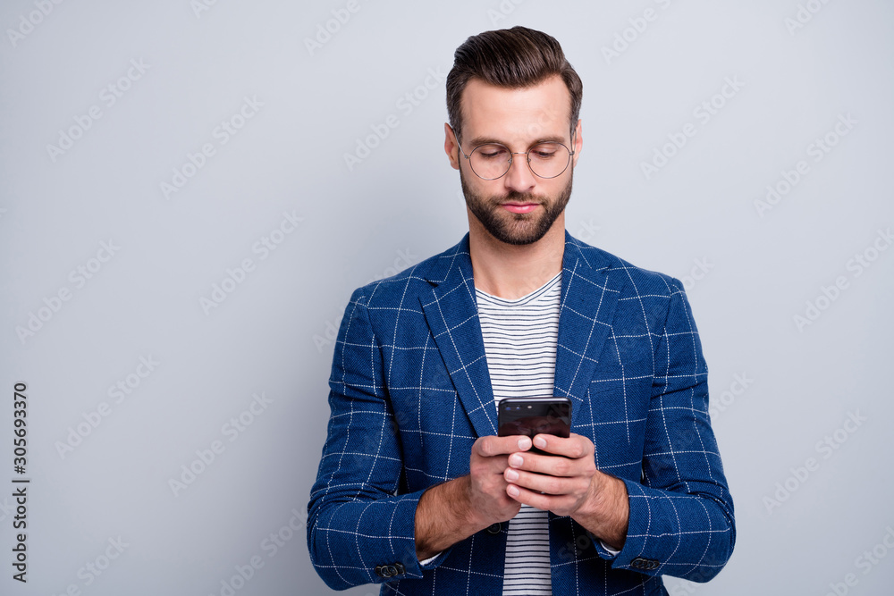 Canvas Prints Photo of concentrated man with bristle looking into screen of telephone while having conversation with business partner isolated grey color background