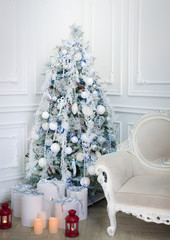 Decorated white Christmas tree with presents underneath on white background/ Feast of Christmas/ Happy New Year 