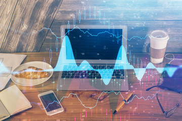 Multi exposure of chart and financial info and work space with computer background. Concept of...
