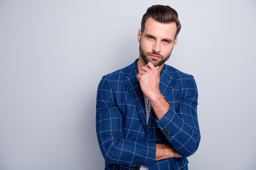 Photo of bewildered puzzled man listening to you attentively touching bearded chin standing confidently isolated over grey color background