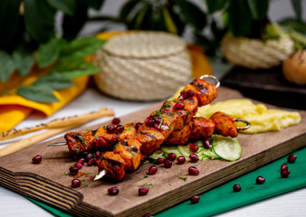 lamb kebab on skewers garnished with pomegranate and herbs © Kamran