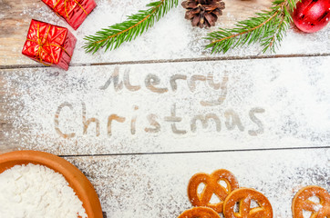 Christmas or new year background concept. Flour text and festive Christmas decoration on the table, cookies, bowl of flour