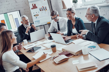 Successful business team analyzing strategy while working in the modern office