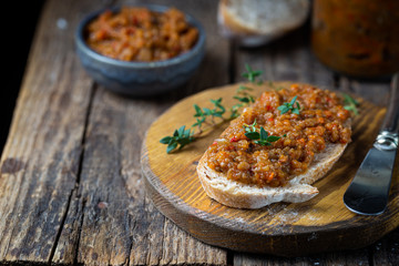 Eggplant dip with bread. Sandwich with eggplant caviar on wooden background - obrazy, fototapety, plakaty
