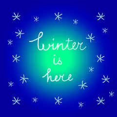 Naklejka na ściany i meble Vector winter season illustration with handwritten words Winter is Here and stylized snowflakes on blue background.