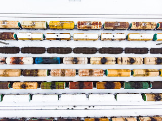 Aerial view of colorful freight train cars on the railway station. Wagons with goods on railroad....