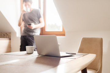 Man telecommuting, coffee break in the morning