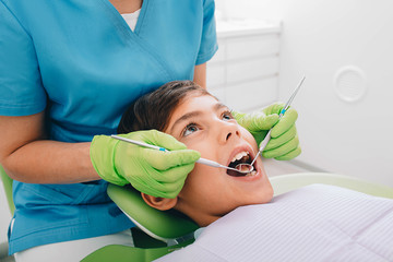 children's teeth exam. Close-up little boy having teeth exam at dental clinic