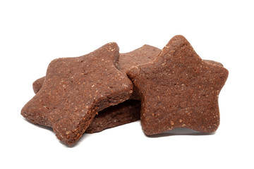 A pile of delicious homemade chocolate and sugar cookies in the shape of stars isolated on a white background. Holiday baking for the whole family