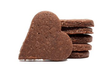 Delicious homemade chocolate and sugar cookies in the shape of hearts, piled up on top of each other and one stands nearby, isolated on a white background. Holiday baking for the whole family