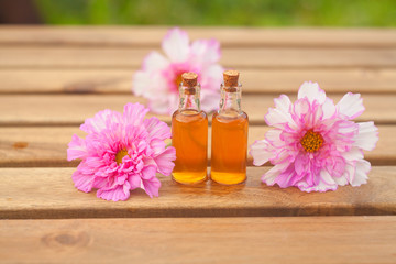 Essence of  flowers on table in beautiful glass Bottle