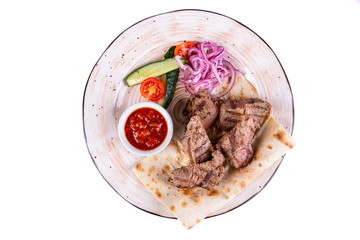 Shashlik of beef on lavash with onion rings