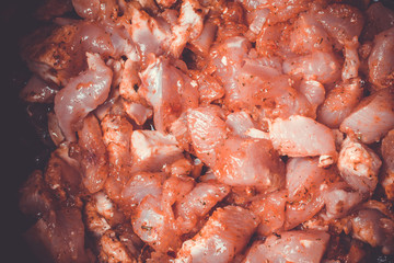 Fresh pieces of raw chicken laid in slow cooker to extinguish.