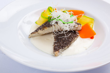 fish in white sauce with vegetables