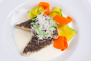 fish in white sauce with vegetables