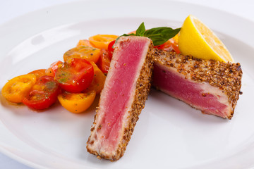 tuna steak with vegetables and lemon