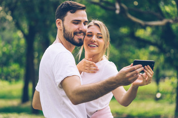 Caucasian couple Lover holding smartphone and smiling to selfie photograph