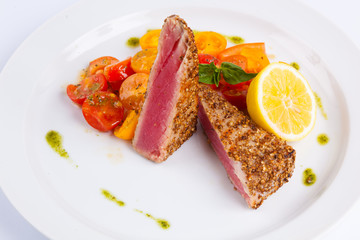 tuna steak with vegetables and lemon