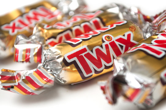 Mulhouse - France - 26 November 2019 - Closeup of Twix chocolate bar by Mars compagny in golden packaging on white background