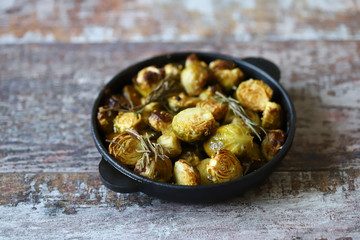 Baked Brussels sprouts with rosemary and spices. Frying pan with baked brussels sprouts.