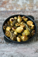 Baked Brussels sprouts with rosemary and spices. Frying pan with baked brussels sprouts.