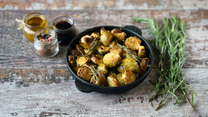 Baked Brussels sprouts with rosemary and spices. Frying pan with baked brussels sprouts.