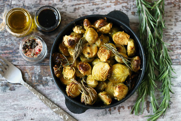 Baked Brussels sprouts with rosemary and spices. Frying pan with baked brussels sprouts.