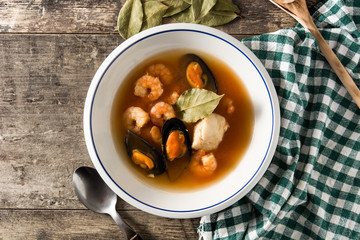 French bouillabaisse soup on wooden table. Top view