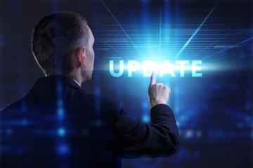 Business, Technology, Internet and network concept. Young businessman working on a virtual screen of the future and sees the inscription: Update