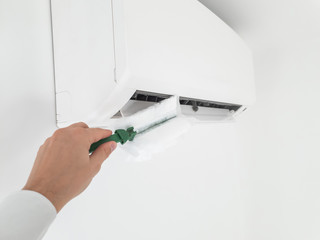 Modern airconditioner unit service - cleaning the housing.