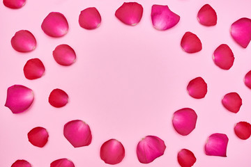 Rose flower petals on pink pastel background, copy space. Spring minimal concept. Greeting card for Womens Day, Mothers Day, Valentine's Day, wedding, birthday. Nature background. Flat lay, top view