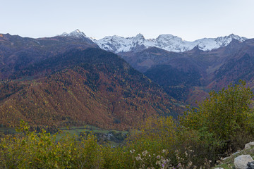Panoramic  view of mountains and peaks in the snow, visible in the distance, in the mountainous part of Georgia - Svaneti at sunset