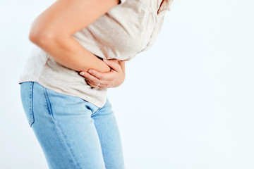 Woman with stomach/ hip issues / problems on the white background.