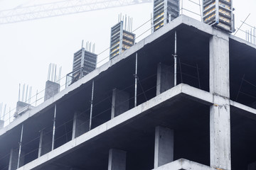 Construction of monolithic concrete construction with construction crane. Housing.