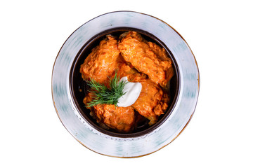 Pigeons with meat, served in sour cream sauce with greens