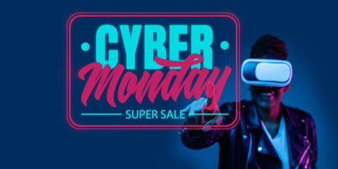 Half-length portrait of young woman in VR-set in neon light on blue backgound. The human emotions, black friday, cyber monday, purchases, sales, finance concept. Trendy colors. Negative space.