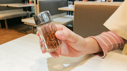 Close up woman hand holding garnish in the restaurant