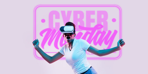 Half-length portrait of young woman in VR-set in neon light on pink backgound. The human emotions, black friday, cyber monday, purchases, sales, finance concept. Trendy colors. Negative space.