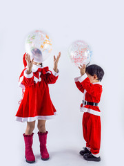 Asian girl and boy is wearing a Santa costume to celebrate Christmas. White background
