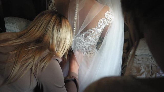 Bridesmaids Buttons bride dress before wedding