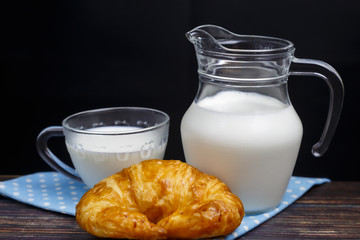 Fresh milk in a jug and a packet Lay on the ground