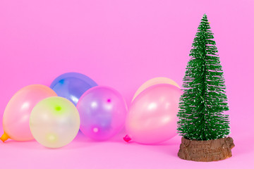 christmas tree with balloons on pink background