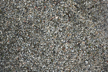 texture of a natural ground with small gray pebbles and sand - park or beach background