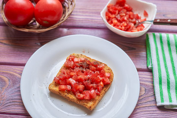 Toasted tomato toast. Vegetarian bruschetta with fresh tomatoes and pepper on white bread.