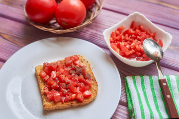 Toasted tomato toast. Vegetarian bruschetta with fresh tomatoes and pepper on white bread.