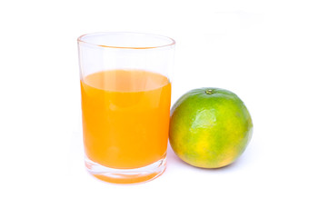 100% of fresh Orange juice in glass with Green oranges and sliced i
