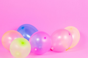 colourful balloons on pink background