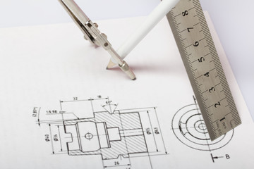 Drawing on a white paper. Above it is a compass. pencil and ruler. Hang in space.