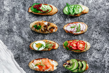 Bruschetta with mushrooms, cucumbers, avocado, radish, salmon and egg