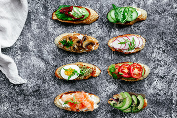 Bruschetta with mushrooms, cucumbers, avocado, radish, salmon and egg
